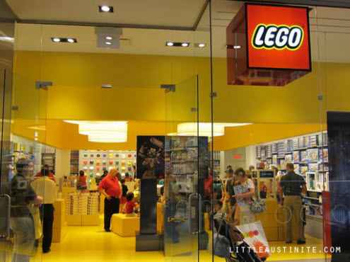 Business branding interiors - yellow - Lego store. This opens a new browser window